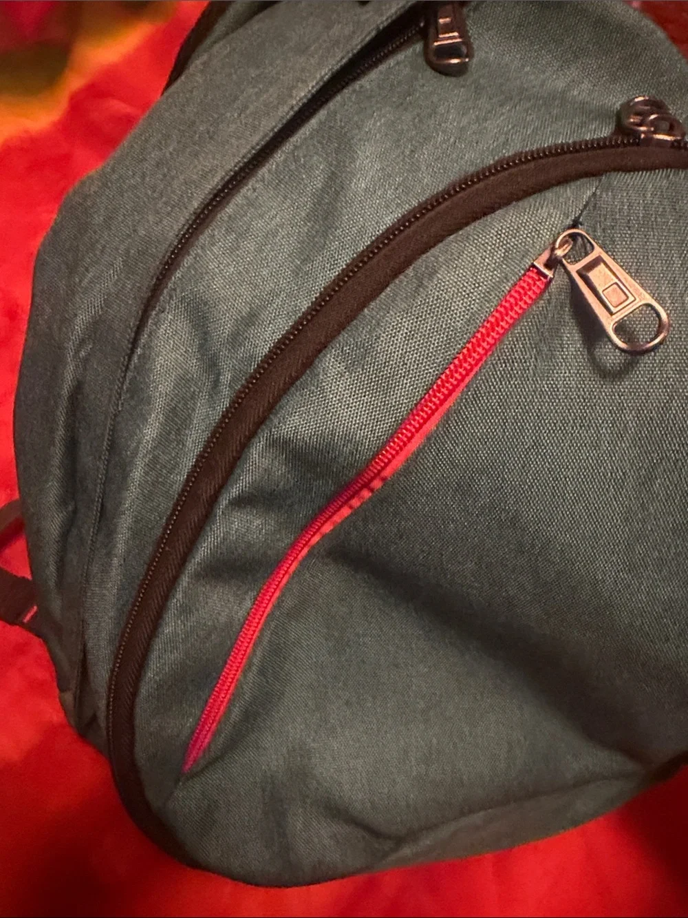 Teal Sling Backpack with Red Accent
